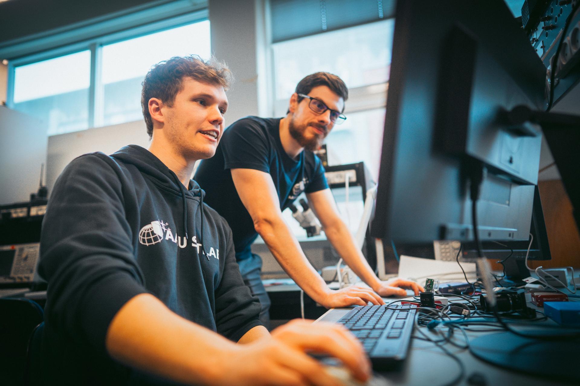 : Associate Professor Israel Leyva Mayorga (right) working closely with students on the development of new satellites and technologies.